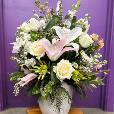 Timeless Elegance Vase - A graceful vase arrangement of creamy white roses, a blush pink lily and white stock accented with soft peach tones and fresh foliage. Classic, elegant and beautifully understated — ideal for anniversaries, sympathy or heartfelt thanks.