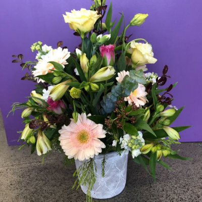 Peaches & Cream Pot - A soft, pretty potted arrangement of peach gerberas, creamy lisianthus, alstroemeria and pops of pink dianthus nestled among fresh eucalyptus and greenery, finished in a textured ceramic pot. Gentle and charming — a lovely long-lasting gift for a birthday or new home.